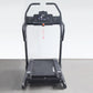 Black electric treadmill with digital display console, handrails, and incline trainer deck on gray floor against white backgr