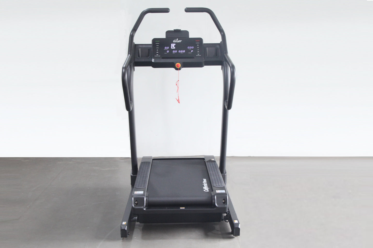 Black electric treadmill with digital display console, handrails, and incline trainer deck on gray floor against white backgr