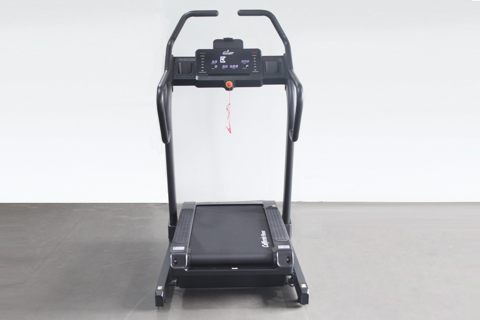 Black electric treadmill with digital display console, handrails, and incline trainer deck on gray floor against white backgr