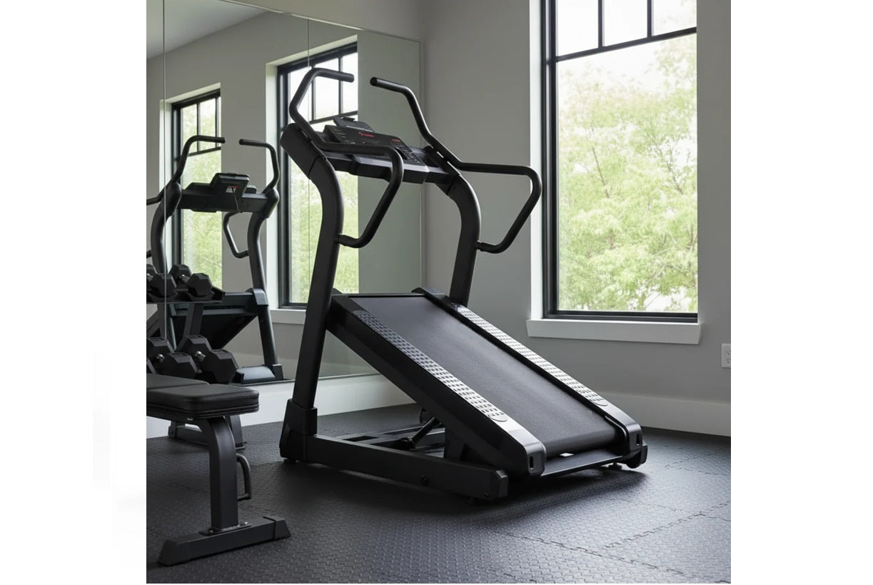 Black motorized treadmill with incline feature and curved handles in modern gym setting with large windows