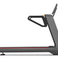 Gray and black treadmill with digital touch console, red accent stripe, and extended handrails on white background