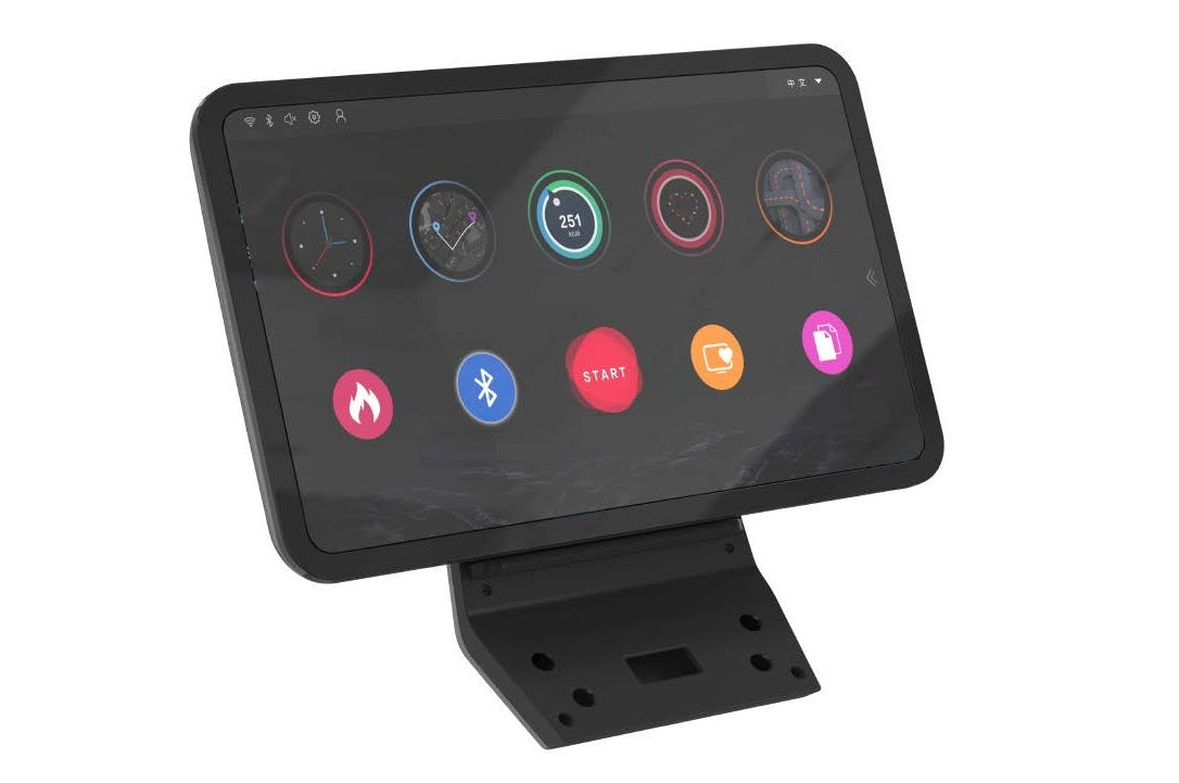 Black fitness tablet console with neon-colored watch faces and app icons on dark display, mounted on stand