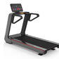 Commercial treadmill with gray and black frame, black running deck with red accent stripe, digital touch console with colorfu
