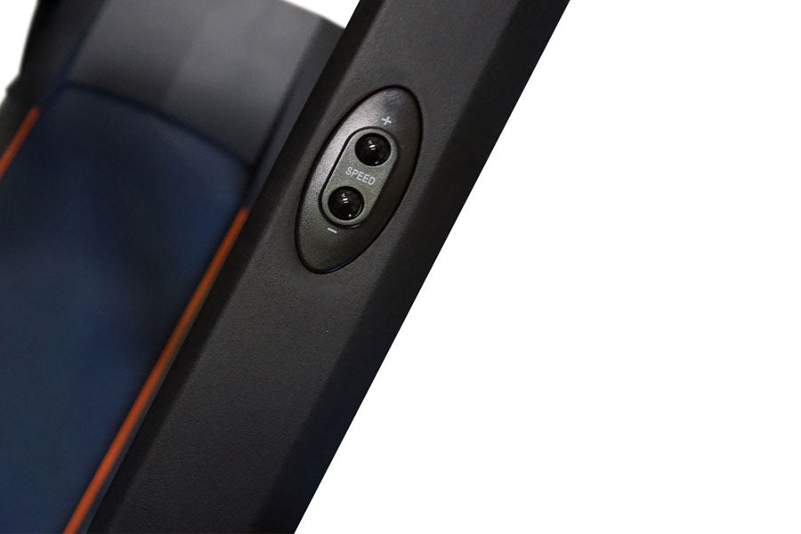 Black folding treadmill control panel with dual speed buttons mounted on side rail, navy blue and red trim visible