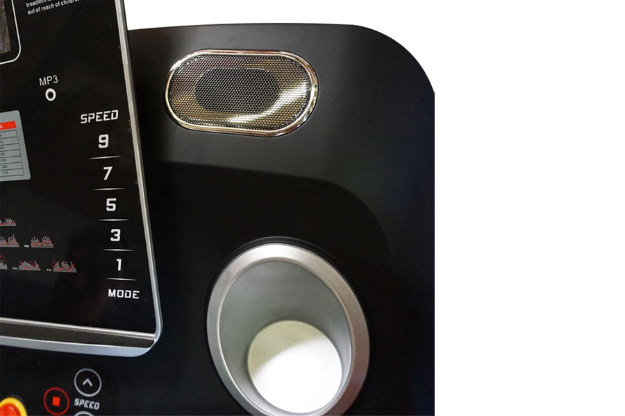 Black treadmill control panel with MP3 indicator, speed dial numbered 1-9, mode button, and chrome-trimmed speaker grille