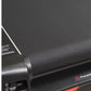 Gray textured treadmill belt and black frame with safety warning label and orange accent detail, flat lay view