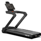 Black M5.5 heavy-duty treadmill with digital display console, angled handrails, and wide running deck on white background