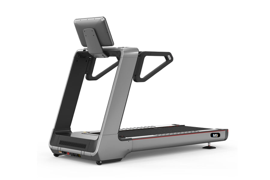 Gray and black motorized treadmill with digital console, handrails, and black running belt on white background
