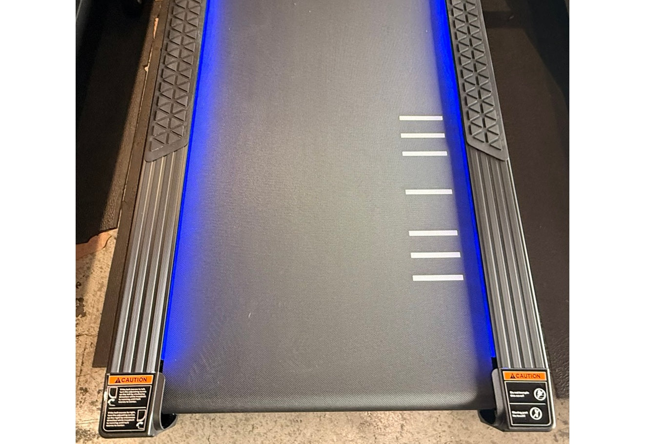 California Fitness Malibu 6.5 treadmill with blue accents, textured running deck, and side rails with caution labels, viewed 