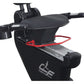 Black recumbent exercise bike with padded seat, red safety harness, handlebars, and foot pedals on white background