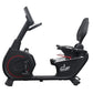 California Fitness R8 recumbent exercise bike with black frame, red accent circle, digital console, and padded seat on white 