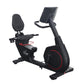 Black recumbent exercise bike with padded seat, red accent wheel, and tablet holder arm on white background