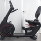 California Fitness RB8 recumbent exercise bike with black frame, red accent wheel, padded seat and backrest, displayed on gra