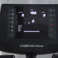 California Fitness recumbent exercise bike console displaying digital screen with time, calories, and watt metrics, black con