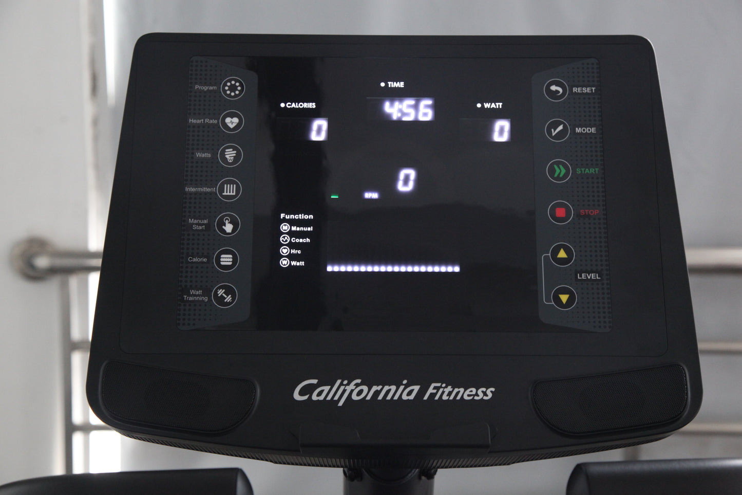 California Fitness recumbent exercise bike console displaying digital screen with time, calories, and watt metrics, black con