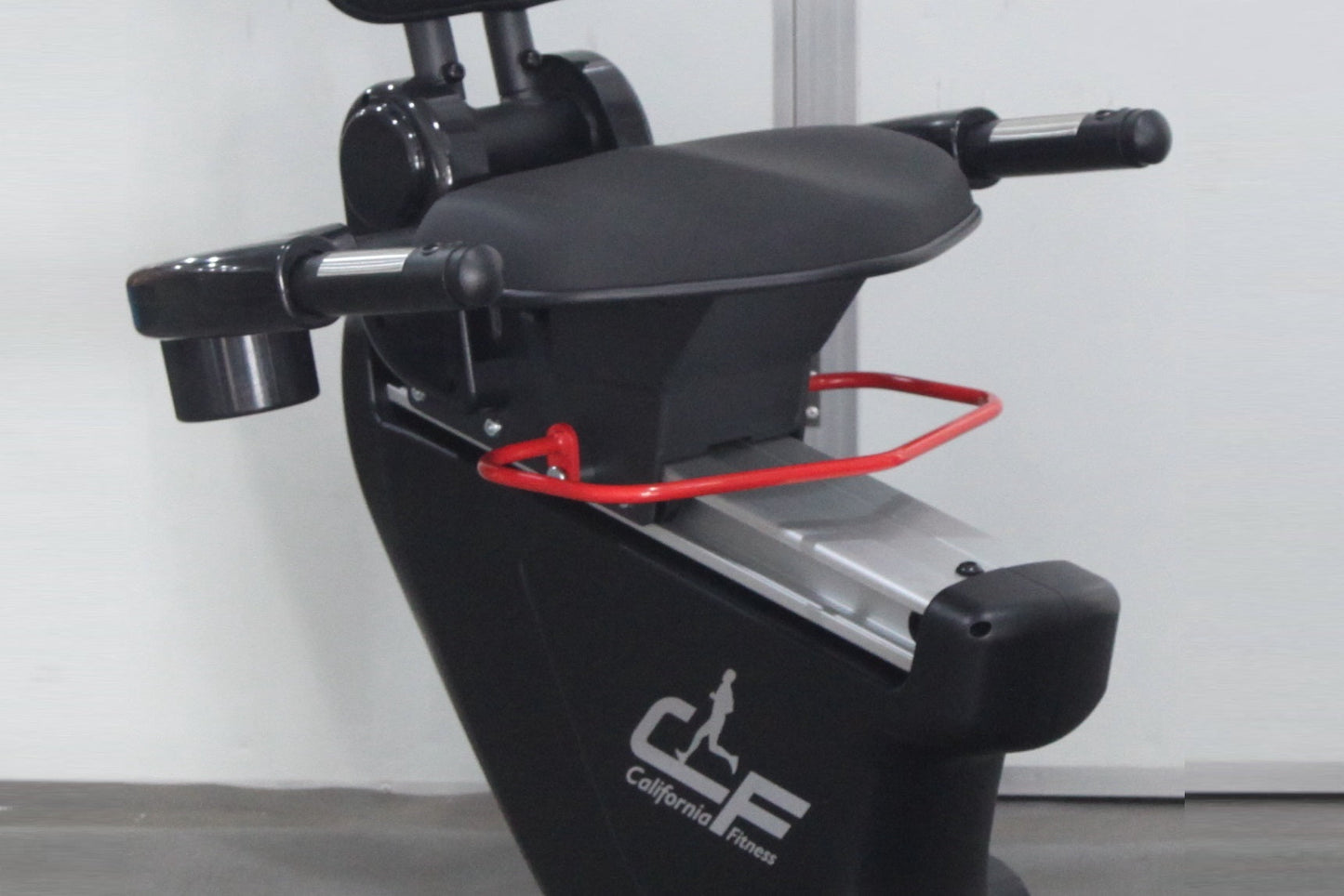 California Fitness R8 recumbent exercise bike with black frame, padded seat, red foot straps, and digital console on white ba
