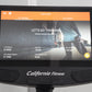 Black recumbent exercise bike with integrated touchscreen display showing iConsole training app interface, orange navigation 