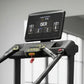Black stair climber stepmill with digital display console showing metrics, mounted on frame with handles