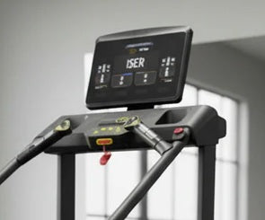 Black stair climber stepmill with digital display console showing metrics, mounted on frame with handles