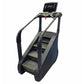 Black and gray commercial stair climber with digital display screen, handrails, and yellow-trimmed steps on white background