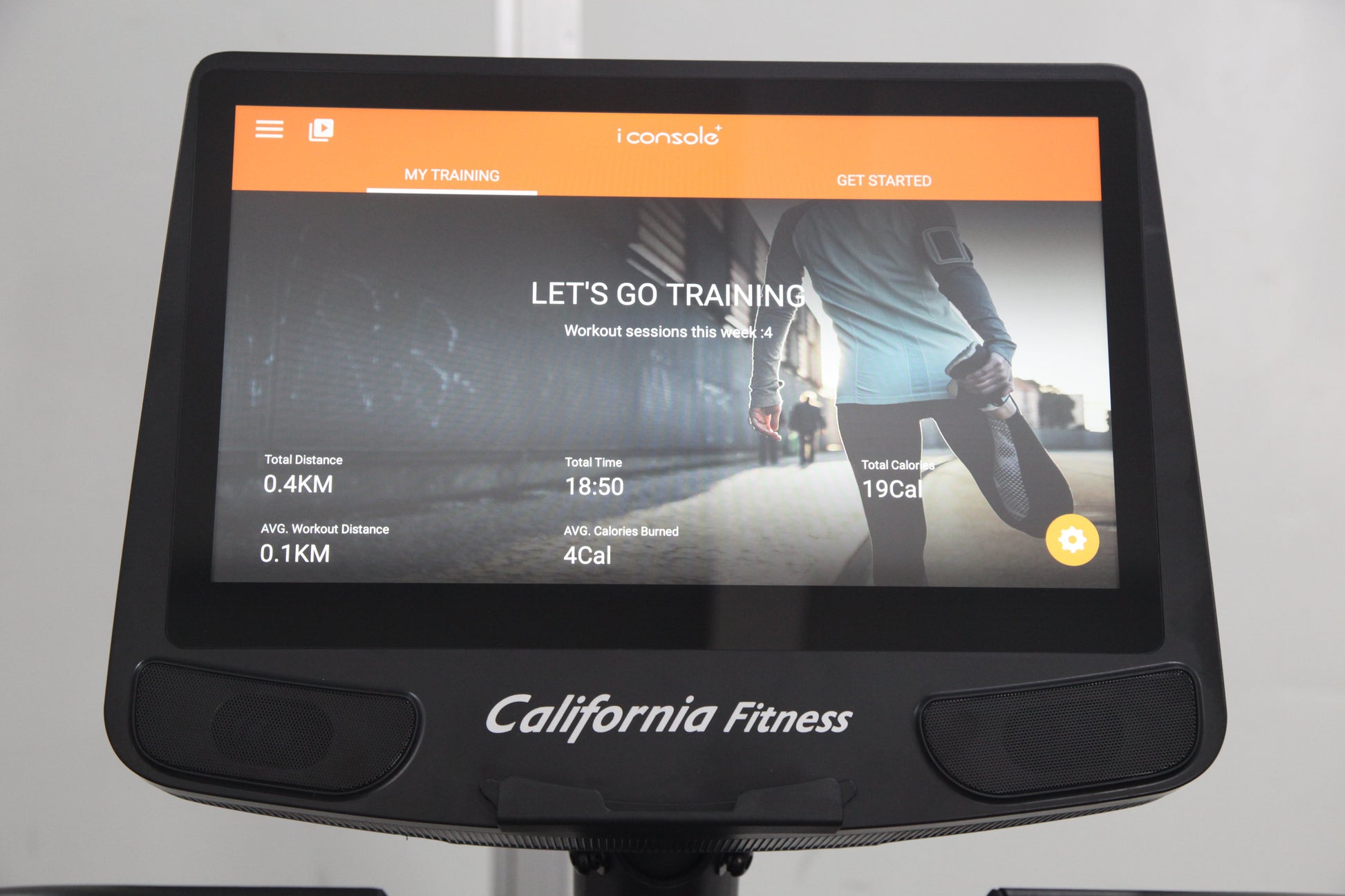 California Fitness U8 upright exercise bike with black frame and touchscreen display showing training interface with orange n