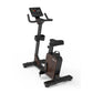 Black and brown upright exercise bike with digital display console, padded seat, and curved handlebars on white background