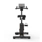 Black upright exercise bike with digital console, padded seat, handlebars, and foot pedals on white background
