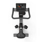 Black upright exercise bike with digital console displaying metrics, curved handlebars, pedals with foot straps, and cushione