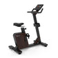 Black and brown upright exercise bike with digital display console, padded seat, and handlebars on white background