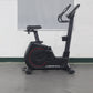 California Fitness U8 black upright exercise bike with red accent wheel and digital display on gray background