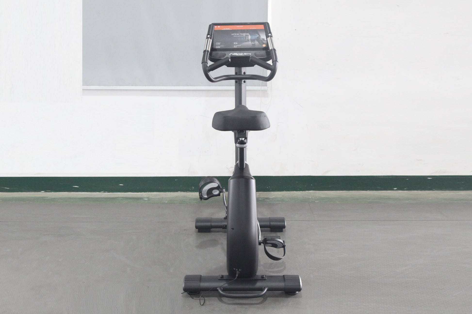 California Fitness U8 upright exercise bike with black frame, padded seat, handlebar console display, and foot pedals on whit