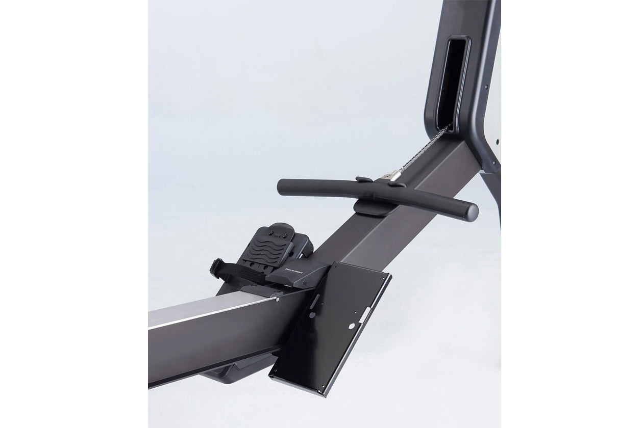 Black hybrid rowing machine with padded seat, horizontal handlebar, and foot pedals on white background