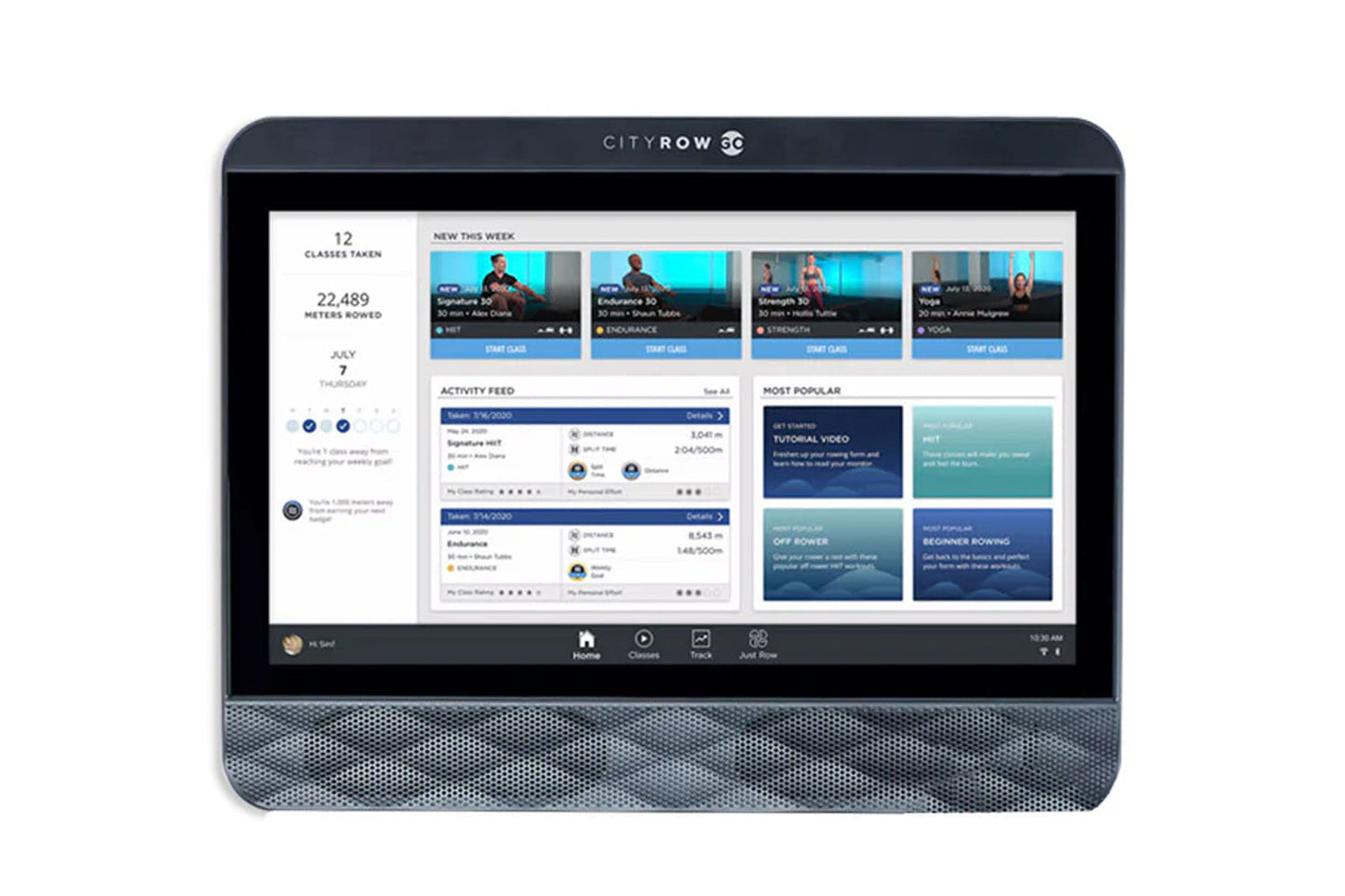Dark gray CityRow SC rowing machine console displaying fitness classes, activity feed, and workout metrics on touchscreen dis