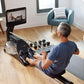 Black and wood water rowing machine with digital display, dumbbell storage, and footplate, used by man in home gym setting