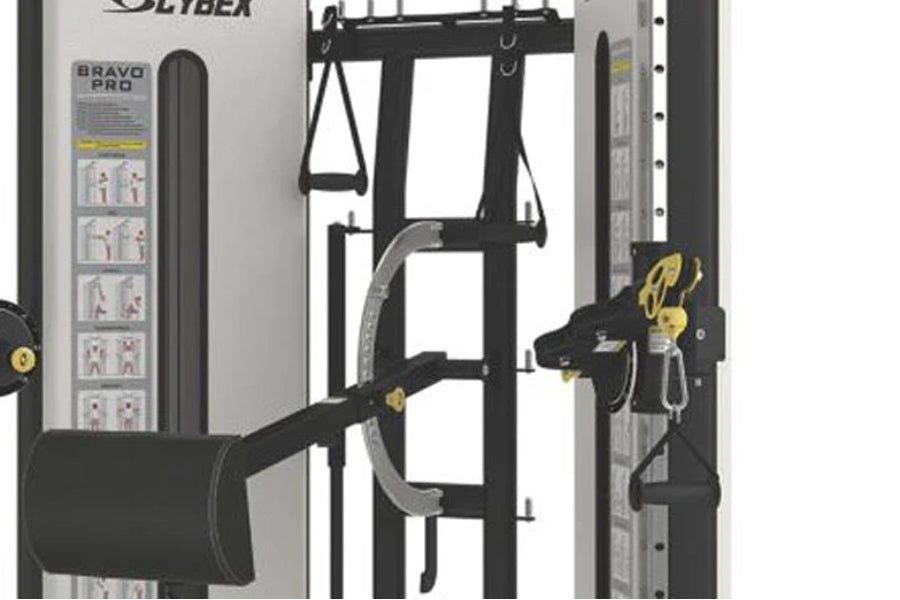 Cybex Bravo Pro advanced functional trainer with black frame, dual weight stacks, and gold-accented cable attachments