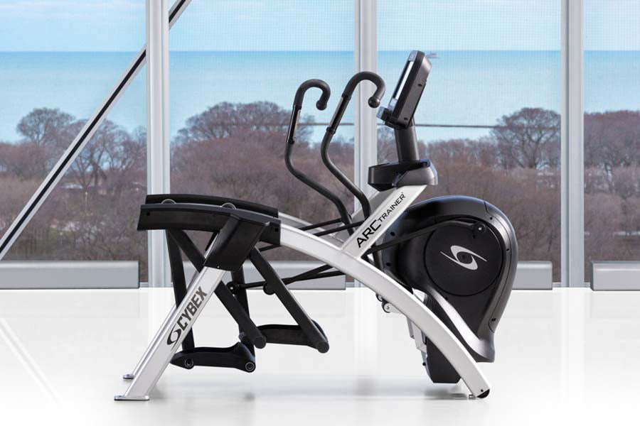 Cybex R Series arc trainer with black seat and handles, silver frame, positioned in front of floor-to-ceiling windows overloo