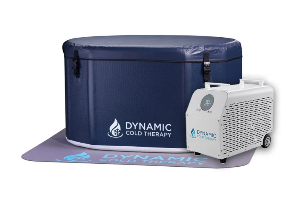 Dynamic Cold Therapy inflatable oval cold plunge tub in navy blue with white chiller unit and purple mat on white background