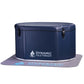 Dynamic Cold Therapy inflatable oval cold plunge in navy blue with white logo and black latches, shown on gray mat with white