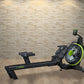 Black and neon yellow rowing machine with digital display, shown on wooden floor against brick wall