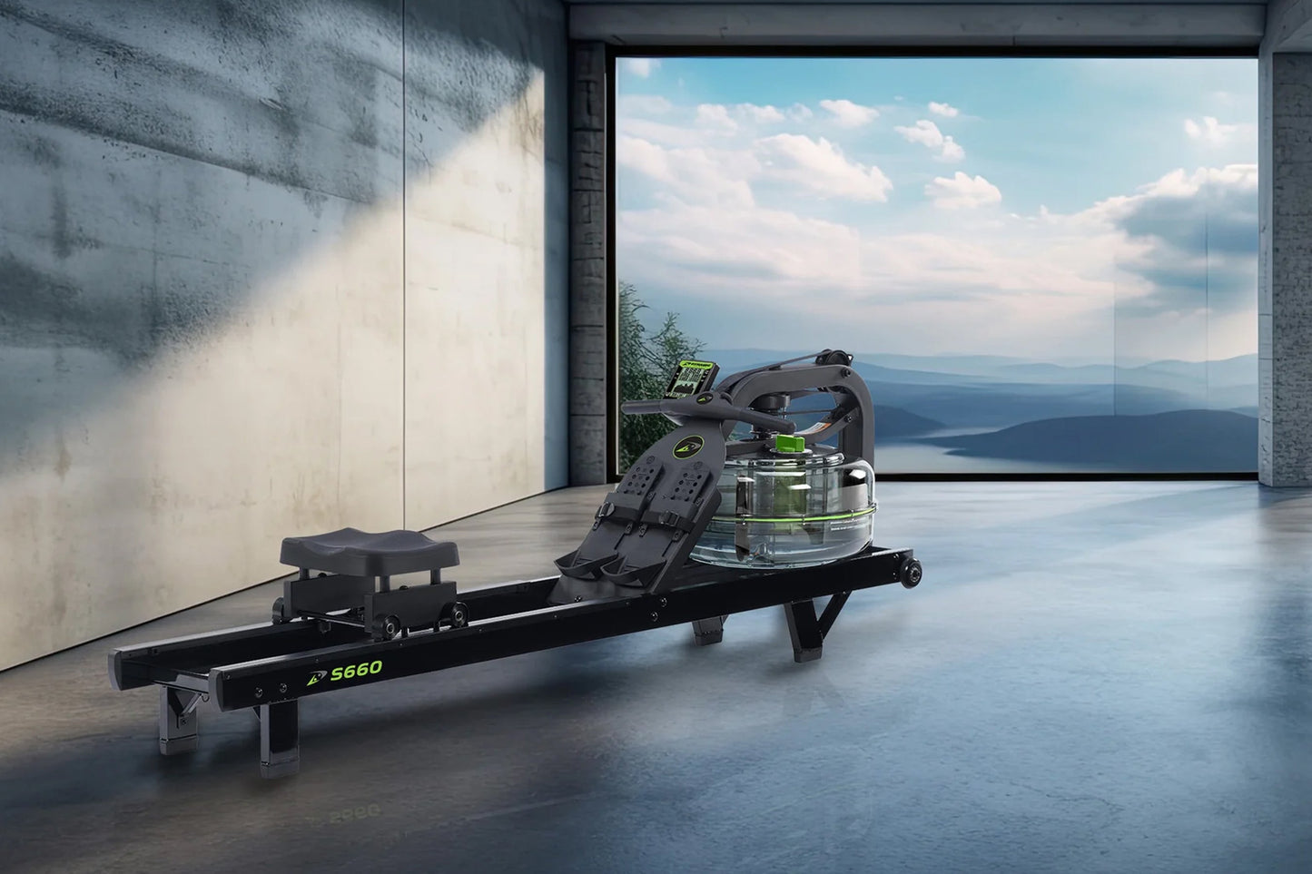 Black S660 rowing machine with fluid resistance tank and digital display, shown indoors with mountain lake view