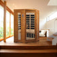 Two-person far infrared sauna with cedar wood construction, glass door with black interior visible, digital control panel, pl