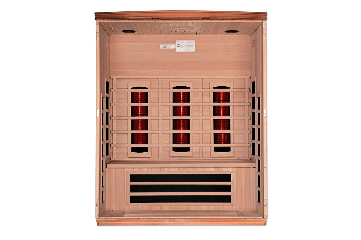 Light wood infrared sauna with open door showing nine red heating panels and black vents, on white background