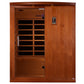 Cedar wood infrared sauna cabin with glass front door, interior bench seating, and digital control panel on right side agains