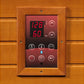 Digital control panel with wooden frame mounted on sauna, displaying 128°F temperature and 60 minutes, featuring red LED disp