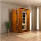 Golden cedar 2-person infrared sauna with glass door and black interior heating panels, shown in bright room setting