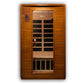 Cedar wood infrared sauna with glass front door, black interior benches, digital control panel, and wood-plank exterior on wh