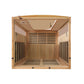 Interior view of light wood sauna cabin with benches, slatted backrest, glass door panels, ceiling vents, and control panel o