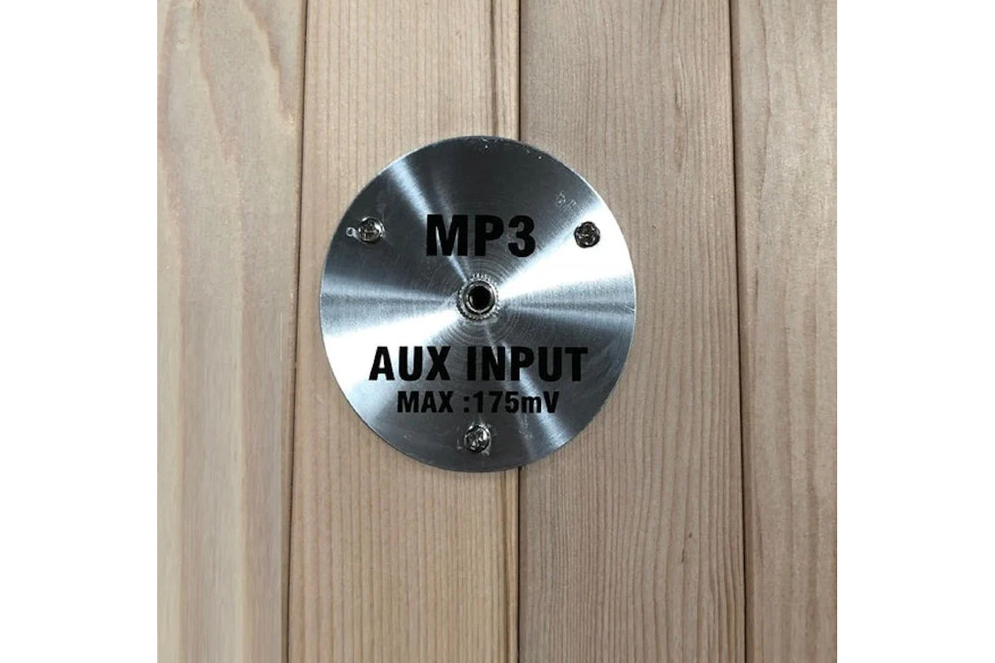 Brushed metal circular control panel with MP3 and AUX input specifications on light wood sauna exterior