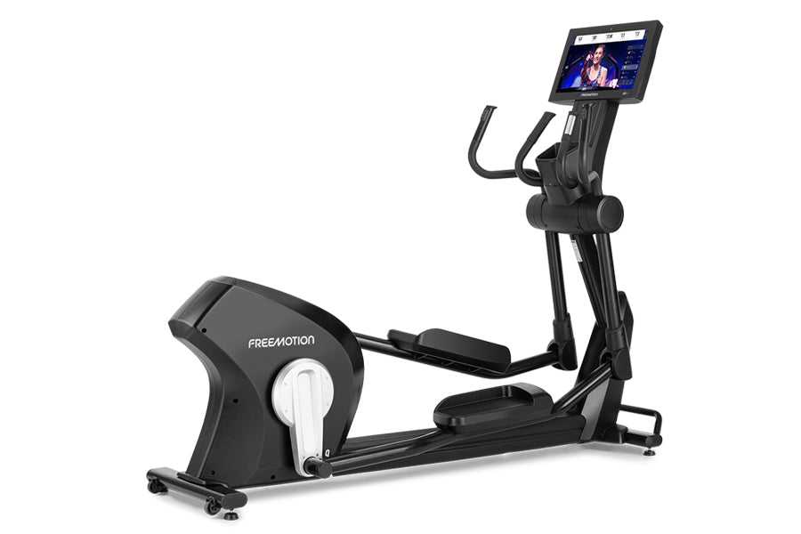 Black Freemotion e22.9 elliptical with tablet display mounted on console, showing cardio workout video on screen