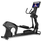 Black Freemotion e22.9 elliptical with digital display screen showing workout video, featuring curved pedals and ergonomic ha